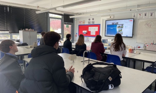 Students watching an online speaker